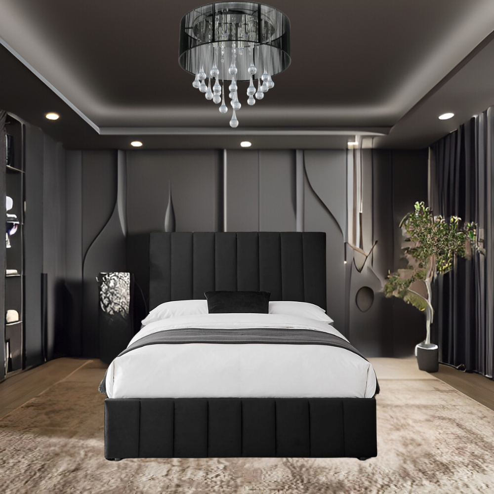 A modern bedroom with a black upholstered FinnPanel bed, white bedding, and a chandelier.