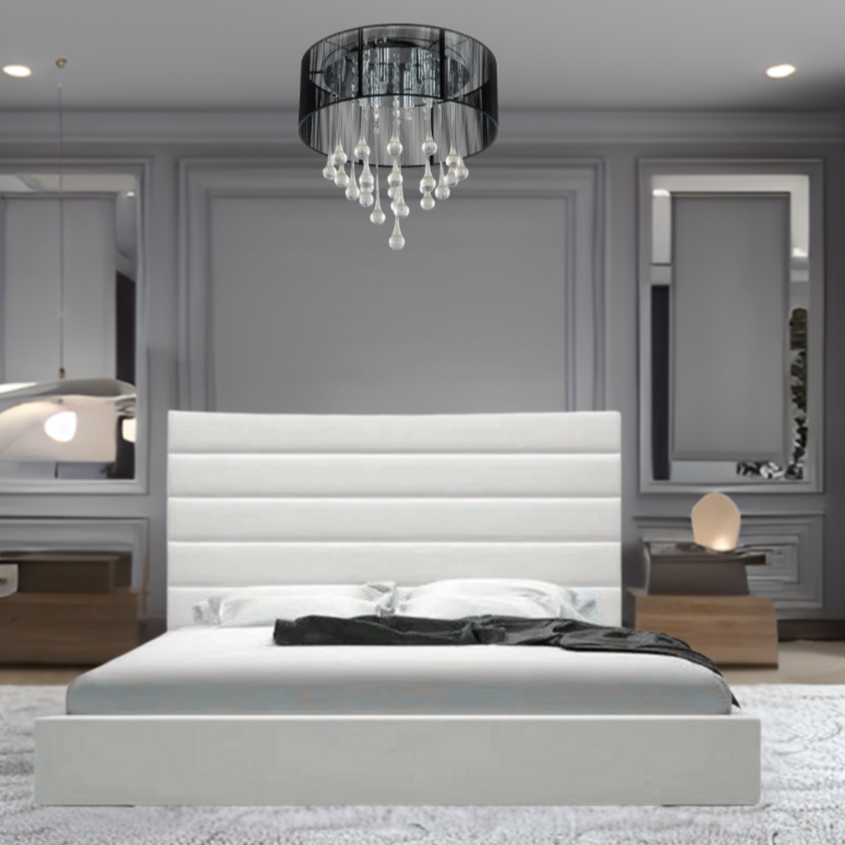 A modern bedroom with a large white Leo Panel Bed, gray walls, and elegant lighting, including a chandelier.