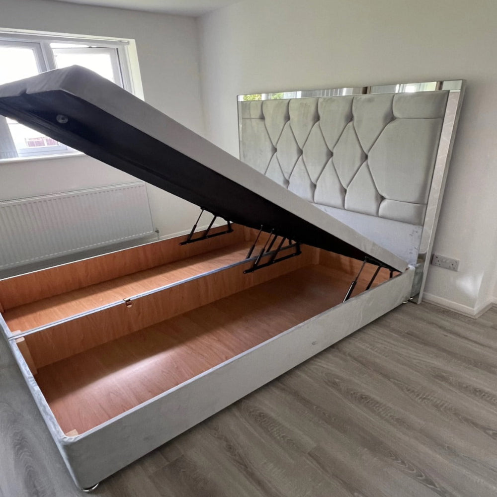 Luke Ottoman Bed - Storage bed with a lifted mattress platform revealing a wooden compartment.