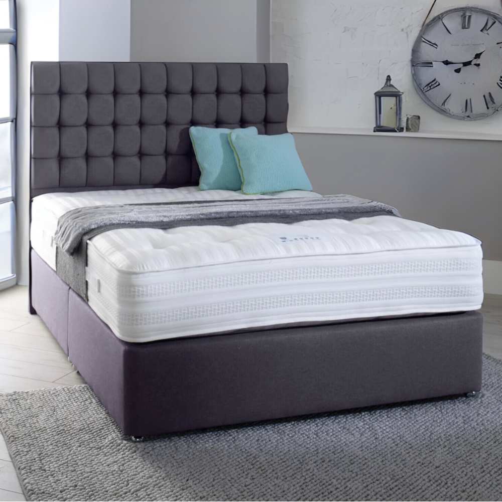 Modern MarioCubeBed with a dark gray tufted headboard, white mattress, teal cushions, and large wall clock.