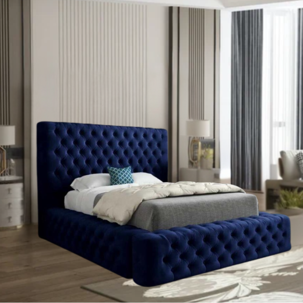 Bedroom with a dark blue tufted MillyAmbassador bed, white bedding, and modern furnishings.