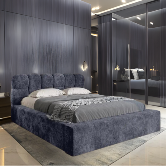 Modern bedroom with a large navy blue Greyson Cube Bed, gray walls, and mirrored wardrobe.