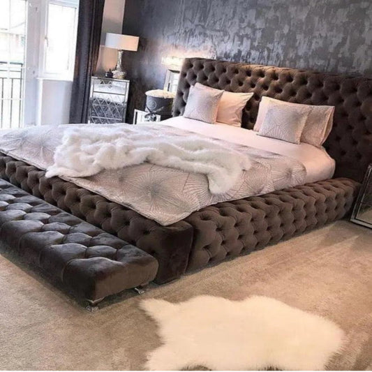 Luxurious bedroom with a Max Ambassador Bed, tufted dark headboard, mirrored bedside tables, and soft lighting.
