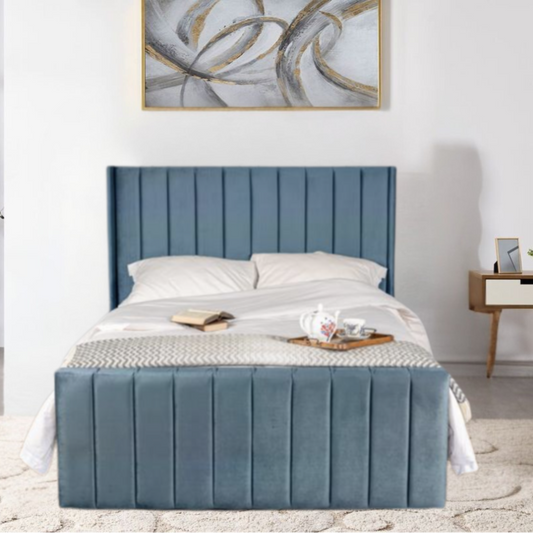 A modern bedroom with a blue upholstered OliverPanelledWingbackBed and abstract painting above it.

