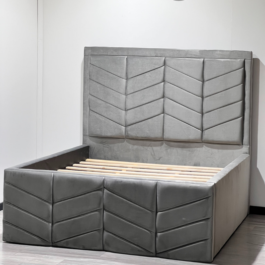 Gray upholstered RyanLuxuryBed with a chevron-patterned headboard and wooden slats.

