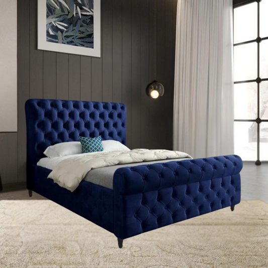 Modern bedroom with a blue velvet tufted SwanSleigh  bed and abstract artwork.

